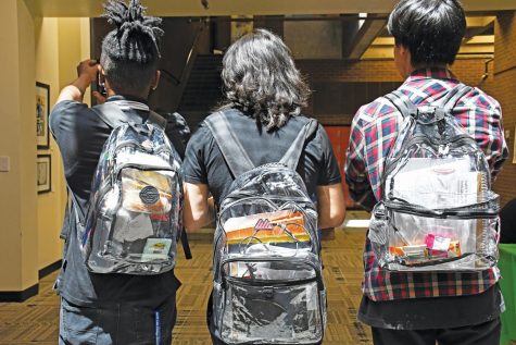 North Lake Campus Early College High School students walk to class sporting their new mandated clear backpacks.