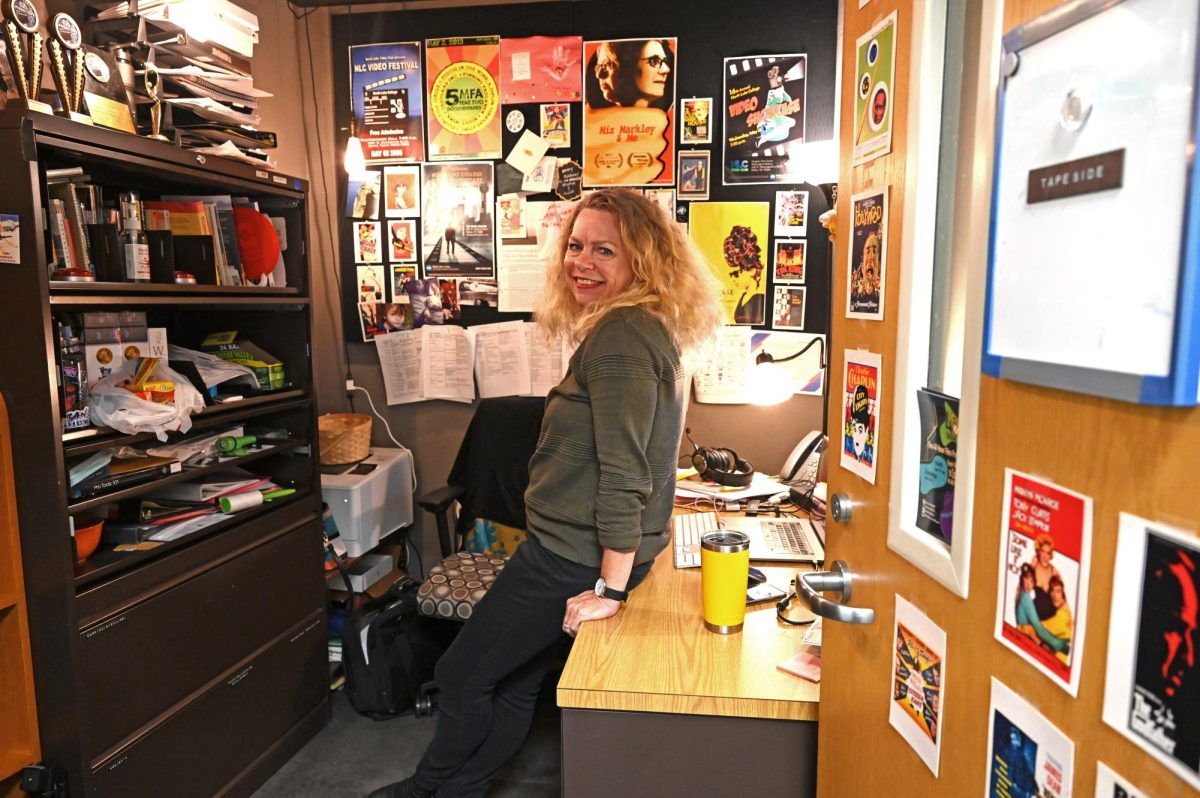 Professor+Sherie+Vance+stands+in+her+office+surrounded+by+posters+of+films+and+past+events.
