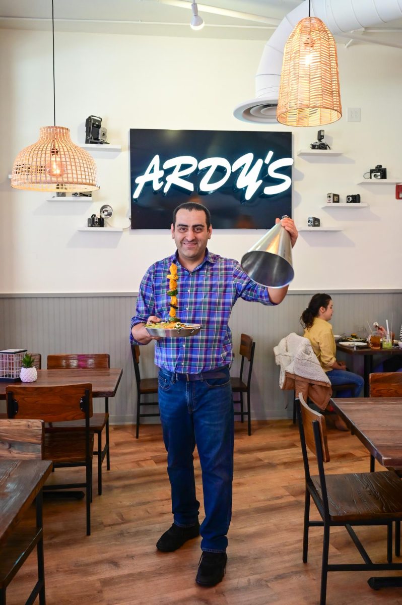 Ardy Badakhshanian at his restaurant, decorated with his collection of old school cameras.
