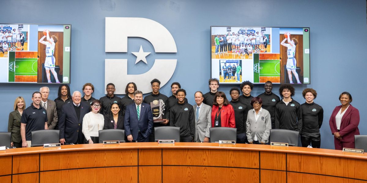 Dallas College board of trustees and North Lake campus basketball players and coaches pose for a photo after The Blazers won their second championship
in three years