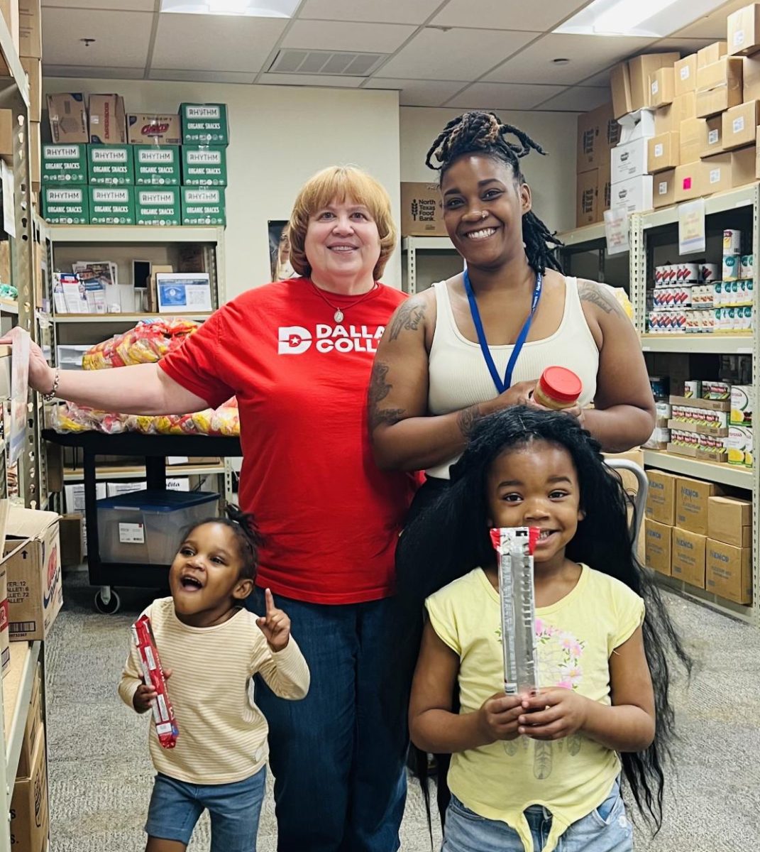 Student Care Coordinator, Kerrie Kenner  introduces Alonzia Starks and her children Ivy and Alana to the food pantry.