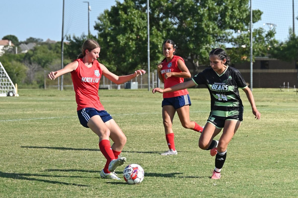 The Blazer's Regan Hair (2) attempts to score the ball while the Bears play defense