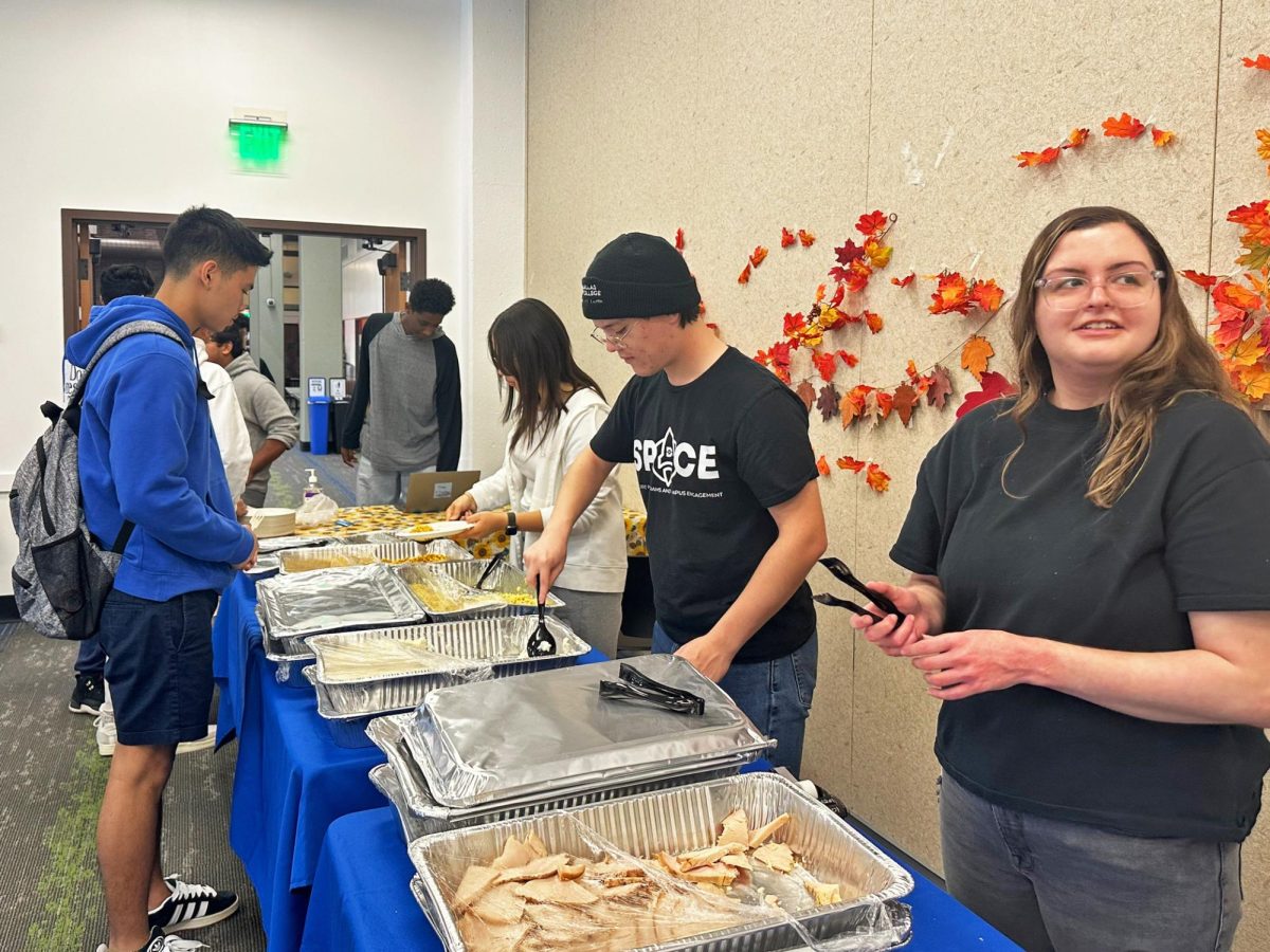 Benjamin Donell(r), serves food to the students during Spacegiving on Nov 6.