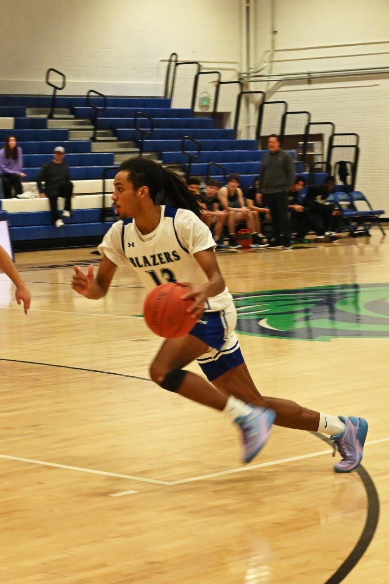 Blazer forward David Clower (13) dribbles up the court during the Jan. 29 game.