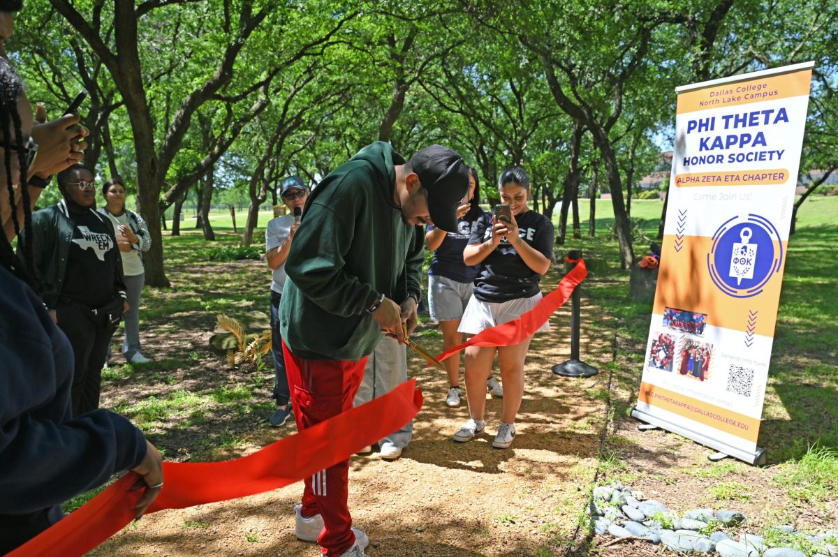 Nieves Turcios cuts the ribbon for the Mindfulness Garden on the Earth Day.
