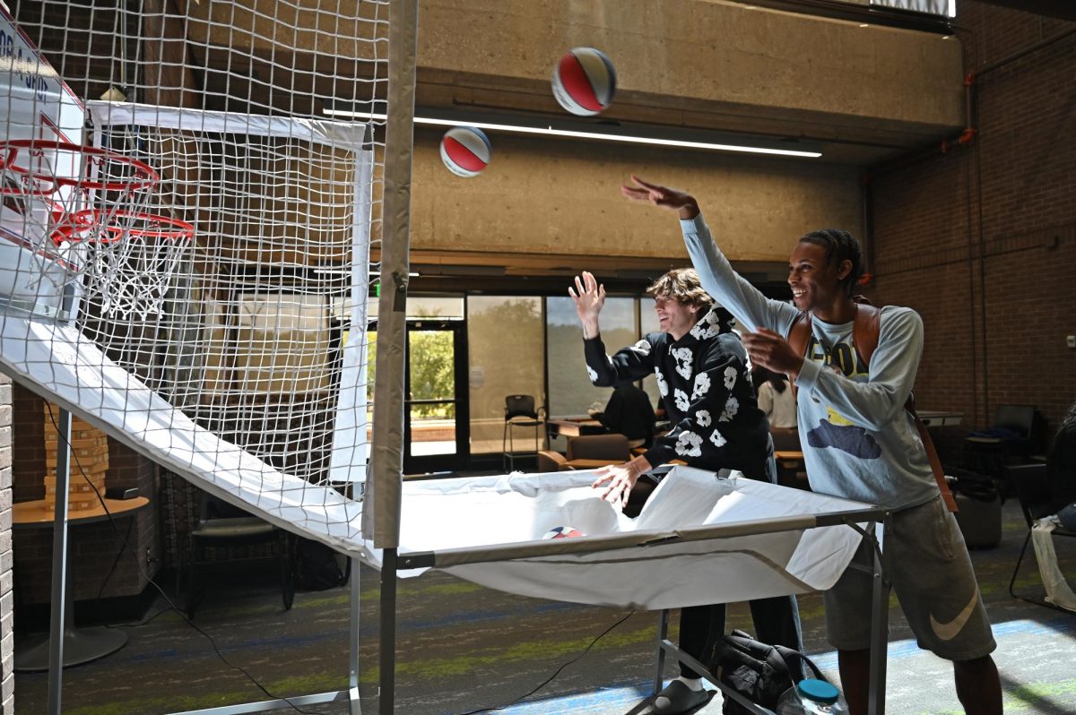 Students have fun and little competition playing cage basketball at the event.