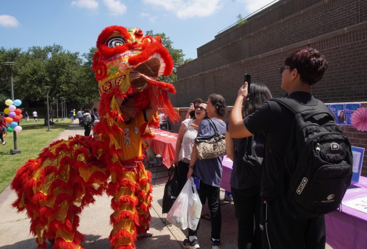 Students interact with the lion dancers performing at the intercultural open house.