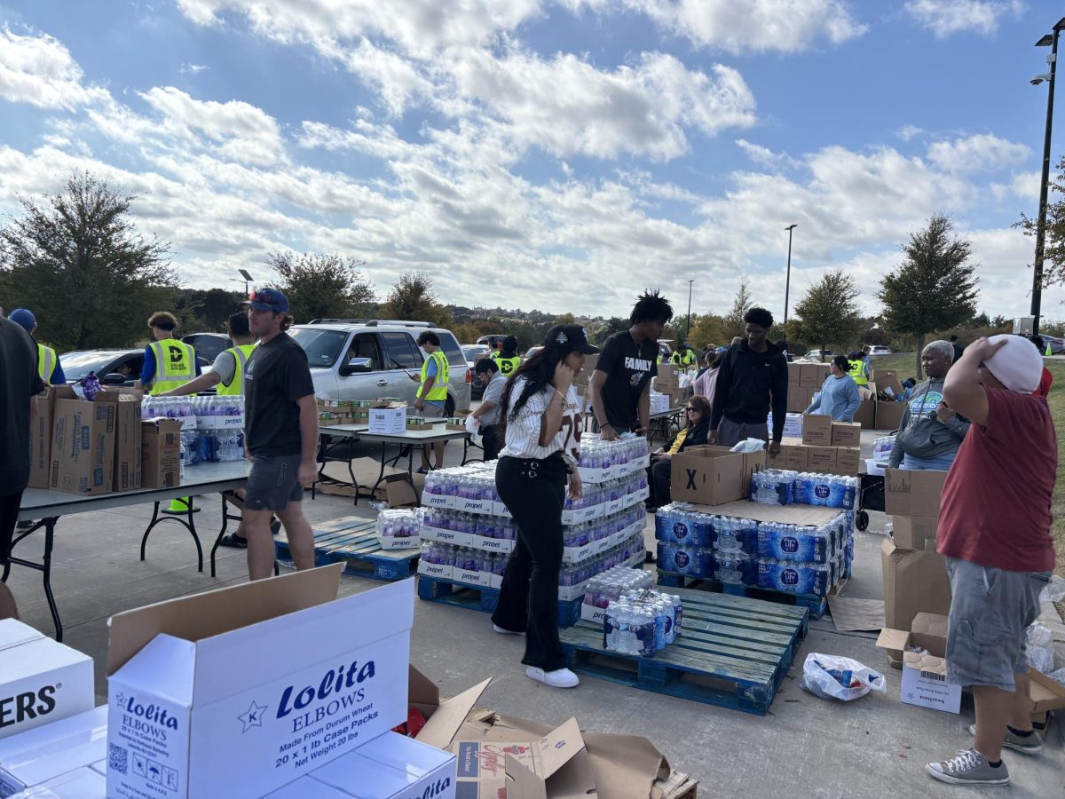 Volunteers distribute food at the drive through food pantry at North Lake Campus on Nov. 11.
