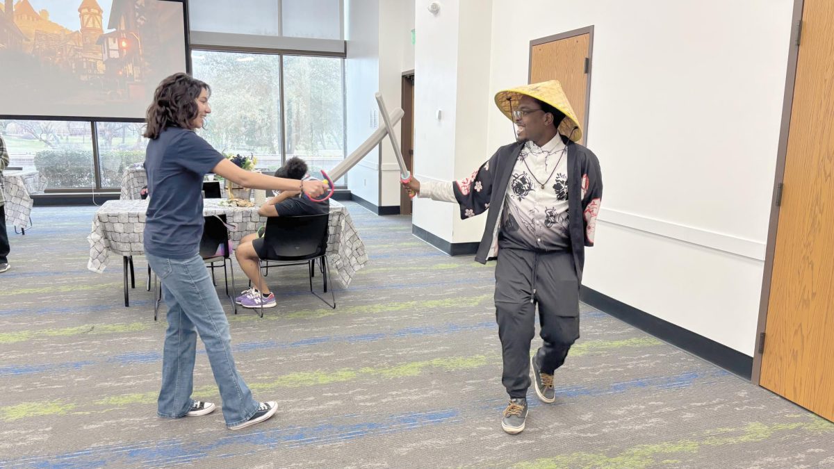 Annette Vidales and Joshua Cheavious playing with swoards during Fort Day.