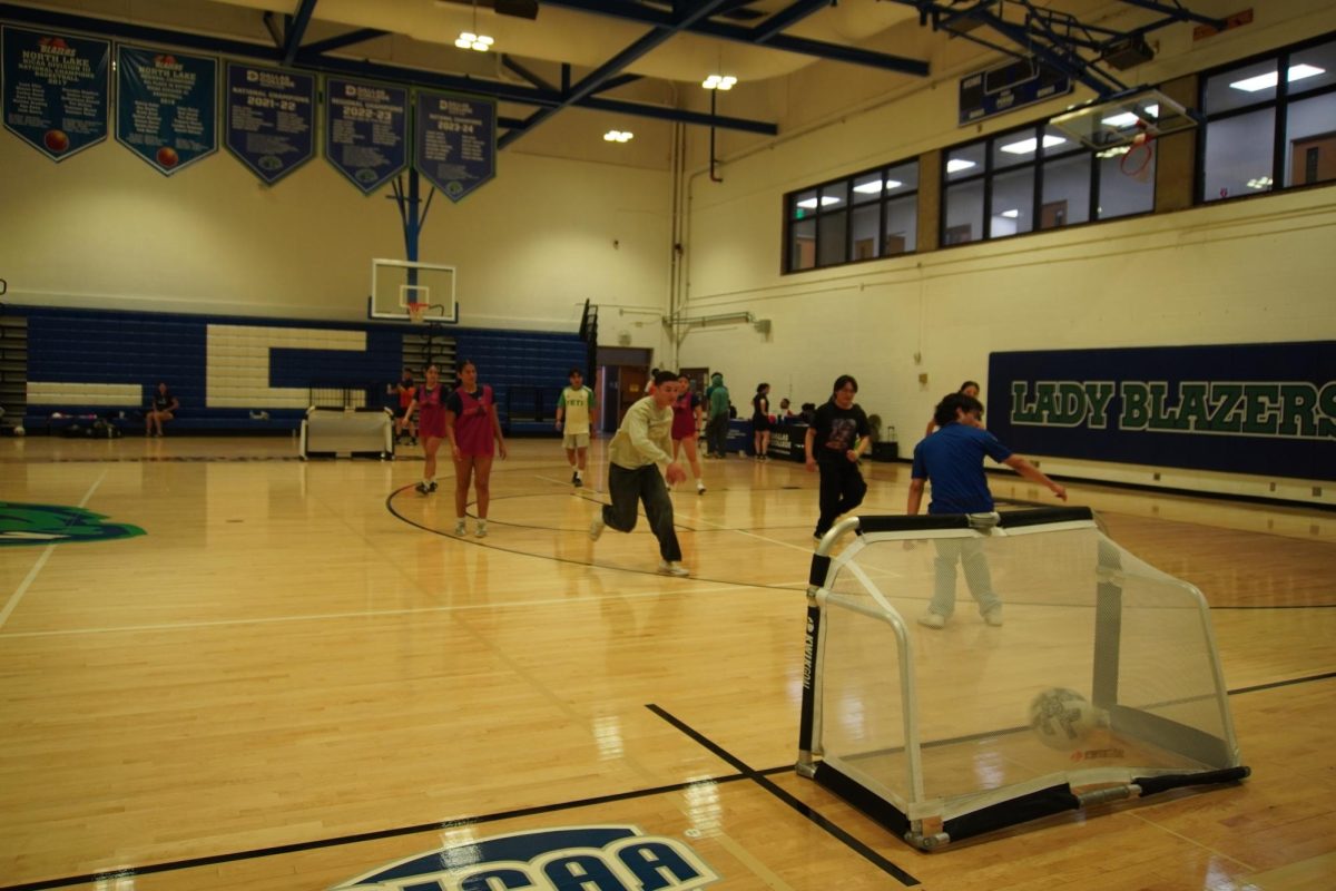 Students play soccer in the gym at the FIFA Fan Fest.