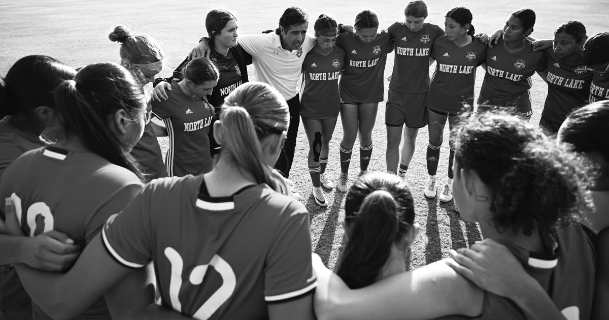 Head Coach Adrian Gonzalez and Assistant Coach C.J. Allen (left) huddle with North Lake players before their semifinal match against Brookhaven. They lost 0-4.