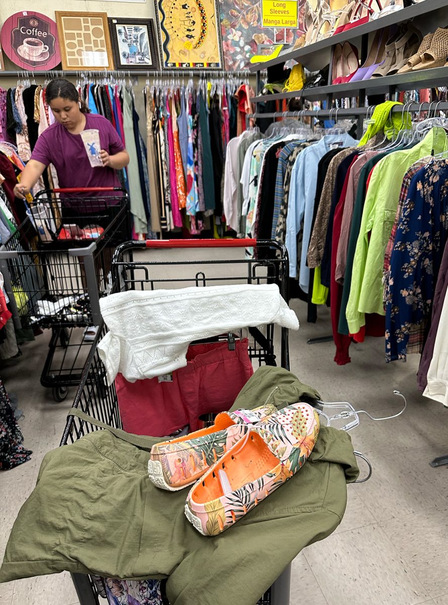Customers look through the aisles for affordable clothes at area thrift stores. 